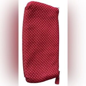 A The Sak, small pink woven shoulder bag with a removable strap.